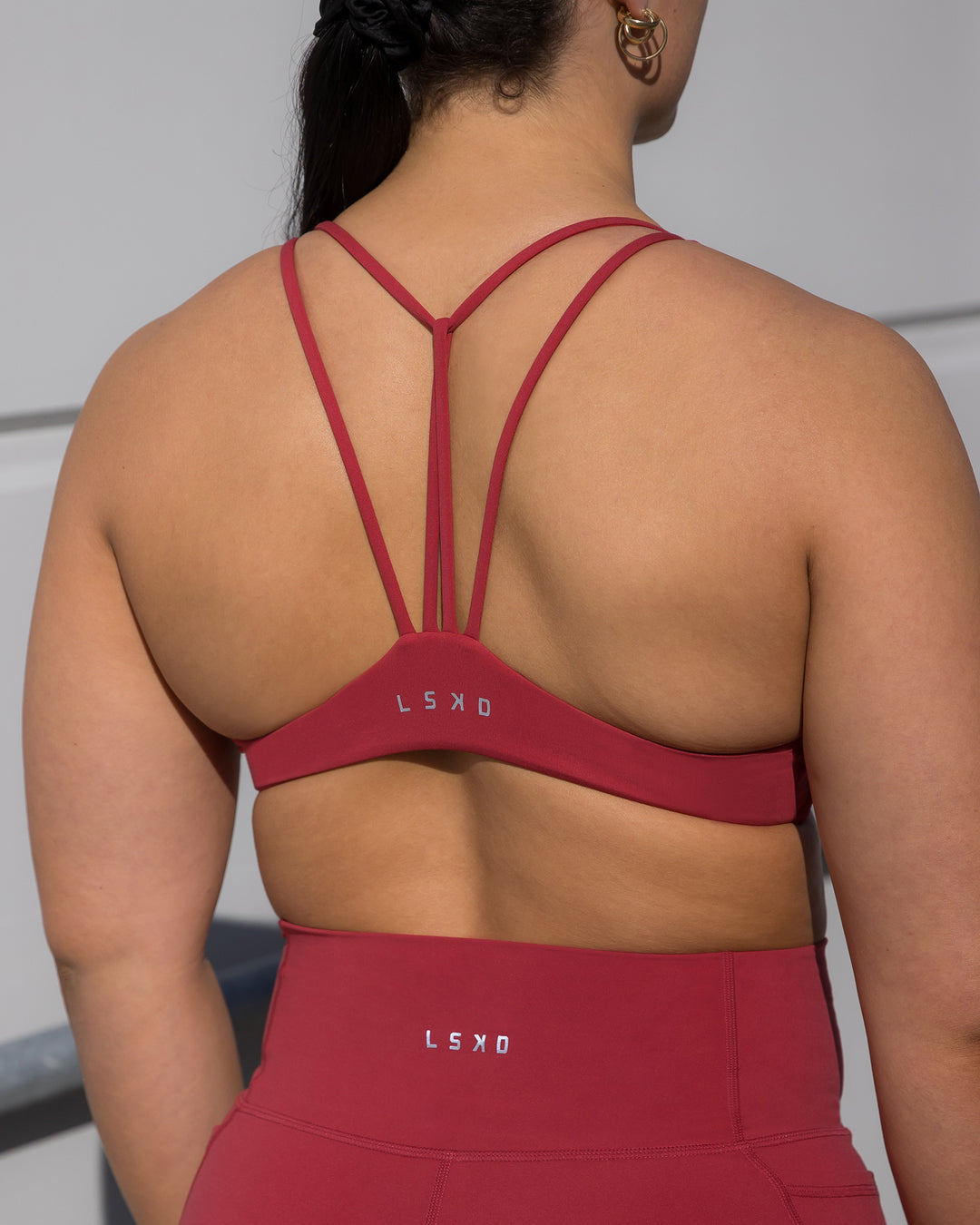 Woman wearing Agile Sports Bra - Claret