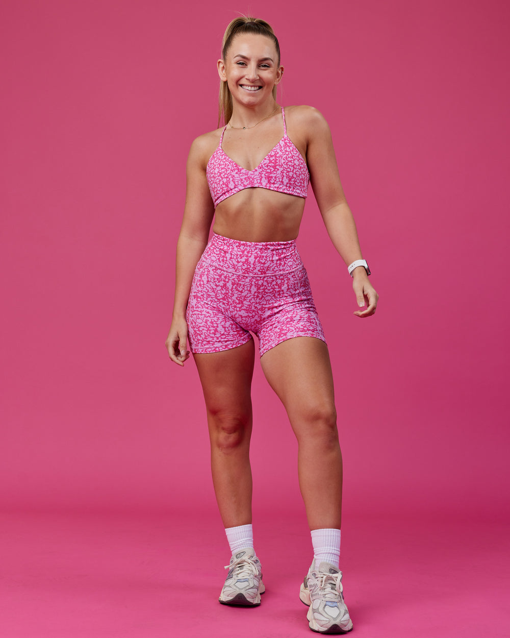 Woman wearing Aura Sports Bra - Patina-Ultra Pink