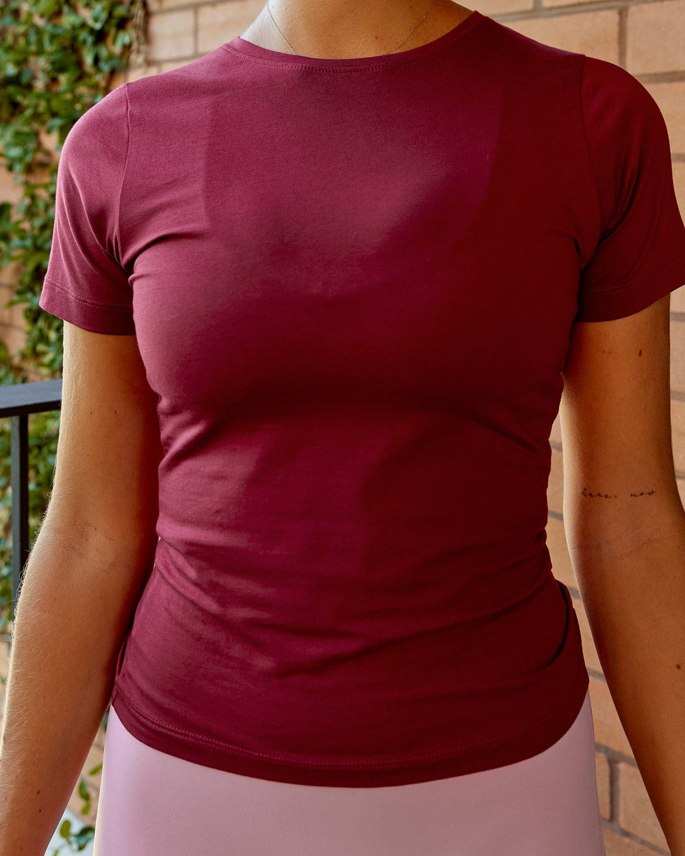 Woman wearing Charge PimaFLX-Lite Fitted Tee - Cranberry