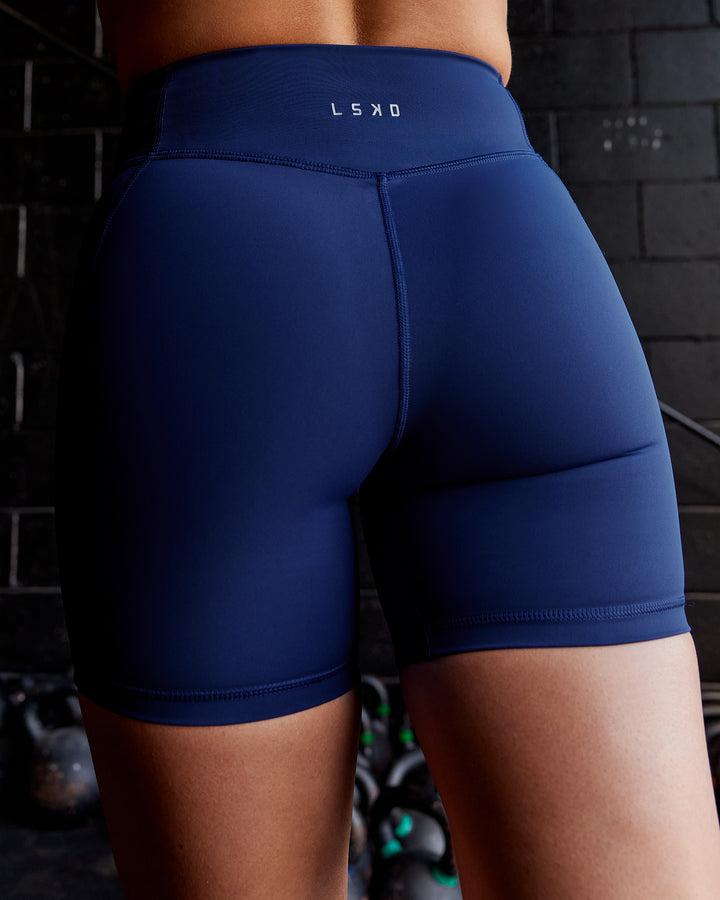 Woman wearing Elite Mid-Length Shorts - Midnight Blue
