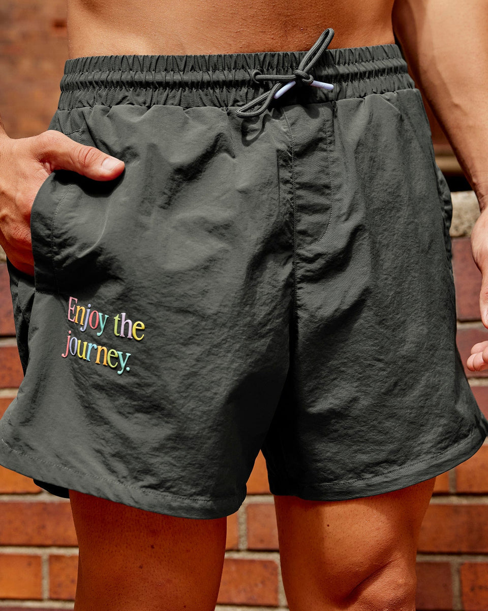 Man wearing Enjoy The Journey Shorts - Pirate Black-Multi