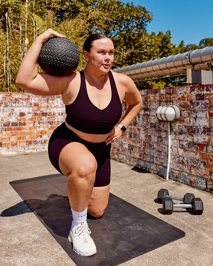 Woman wearing Evoke Sports Bra - Mulberry
