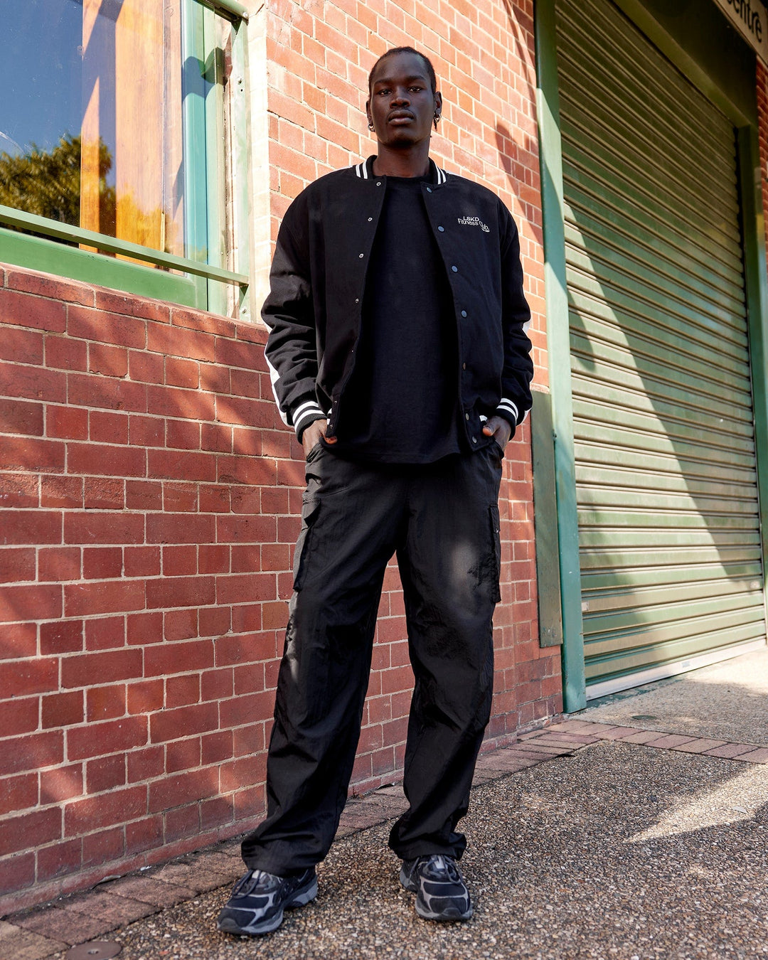 Man wearing Unisex Fitness Club Bomber Jacket - Black-Off White