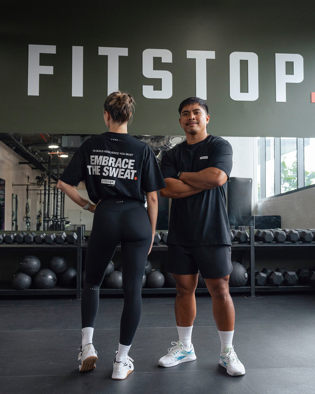 Duo wearing Fitstop Embrace the Sweat FLXCotton Oversized Tee in Black-White | Size:Duo