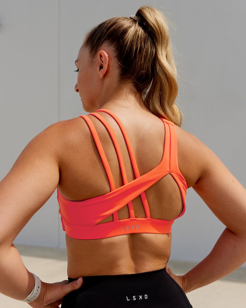 Woman wearing Galvanise Sports Bra - Ultra Orange