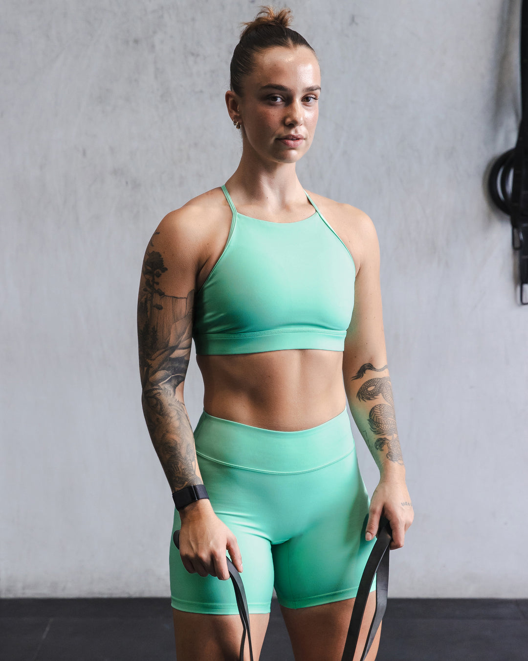 Woman wearing Lift High Neck Sports Bra - Cockatoo