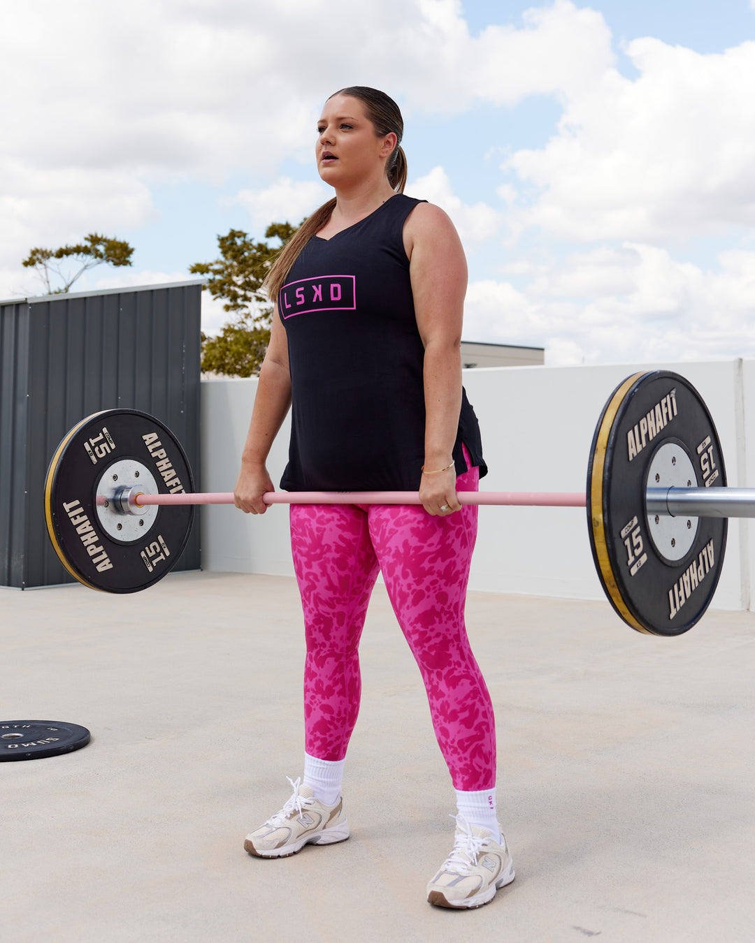 Woman wearing Luna FLXCotton Longline Tank - Black-Ultra Pink