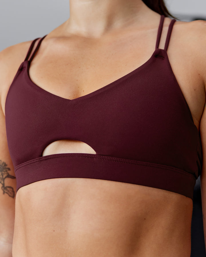 Woman wearing Pursue Sports Bra - Dark Cherry
