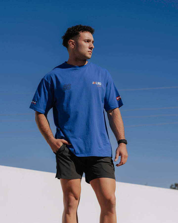 Man wearing Unisex Redline FLXCotton Tee Oversize - Power Cobalt-White
