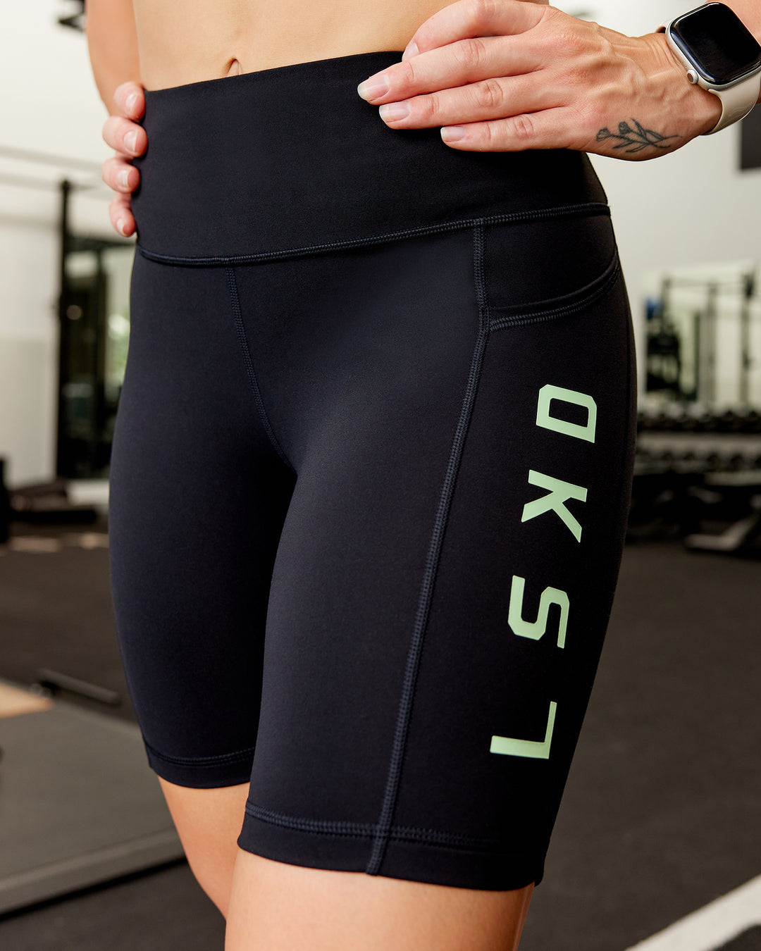 Woman wearing Rep Bike Shorts - Black-Surreal Green