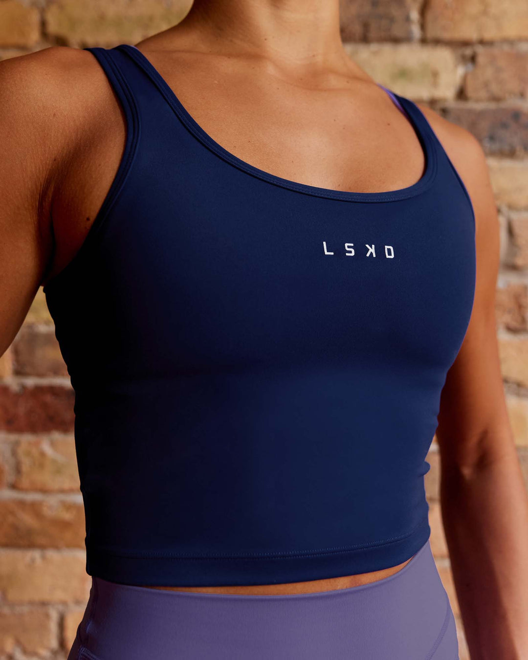 Woman wearing Staple Active Cropped Tank - Midnight Blue