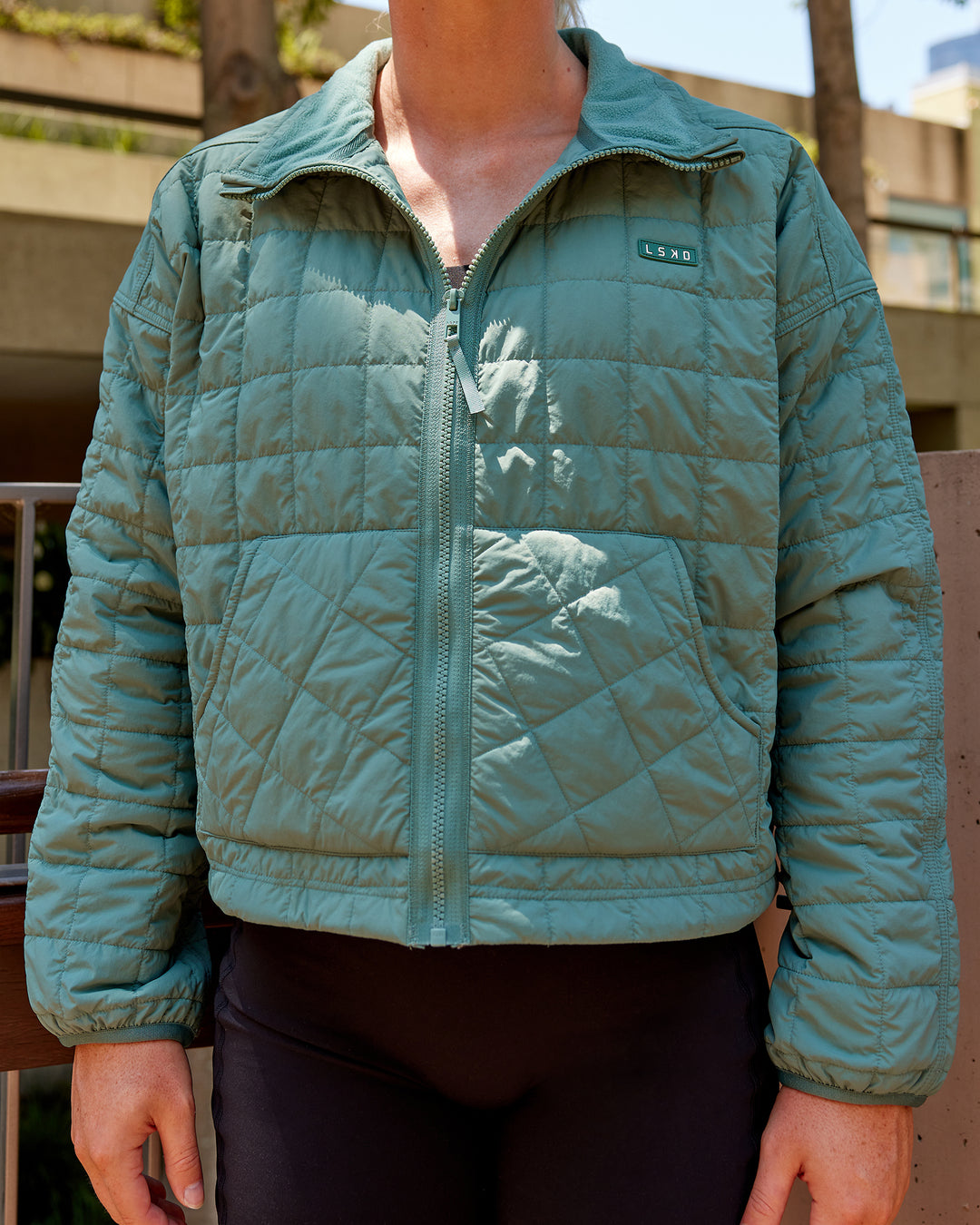 Woman wearing Thrive Packable Jacket - Sagebush