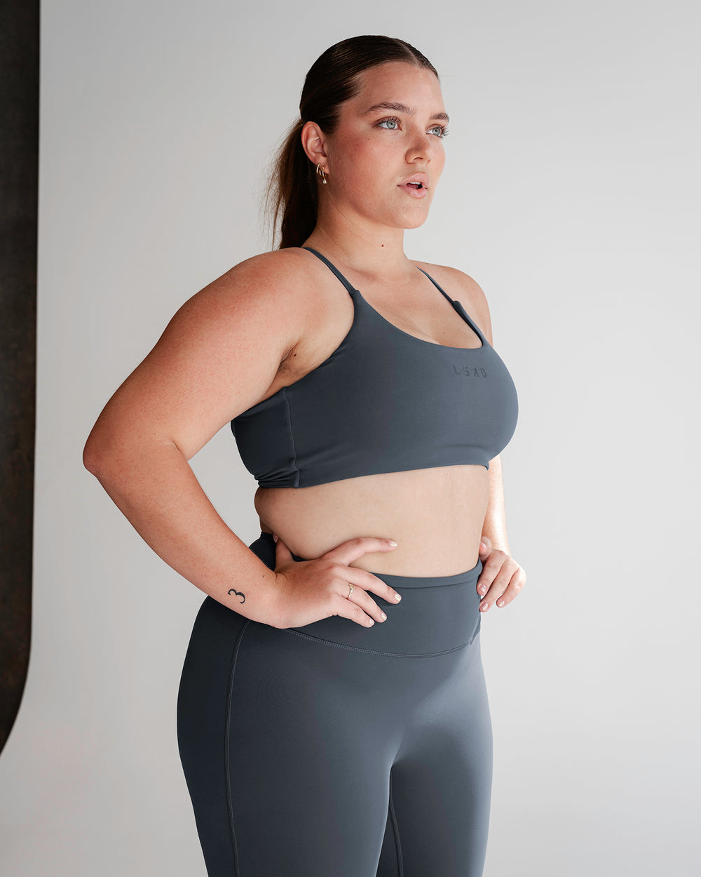 Woman wearing Twist Sports Bra - Turbulence