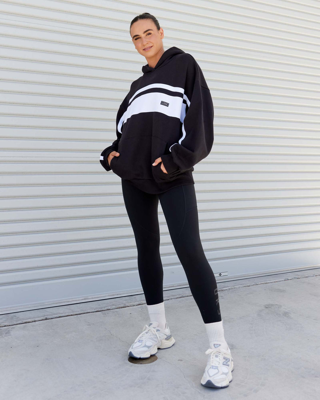 Woman wearing Unisex Intercept Hoodie Oversize - Black-White