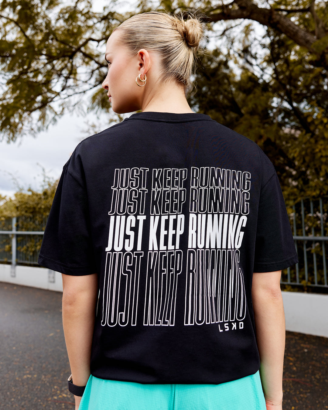 Woman wearing Unisex Keep On Running FLXCotton Oversize Tee - Black-White