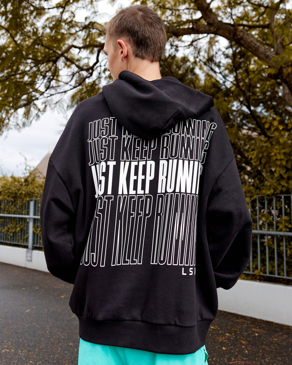 Man wearing Unisex Keep on Running Hoodie Oversize - Black-White