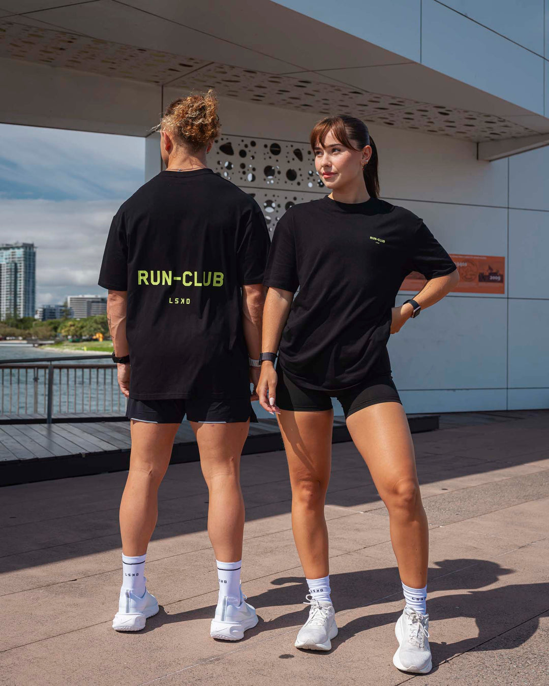 Duo wearing Unisex RUN CLUB FLXCotton Tee Oversize - Black-Volt