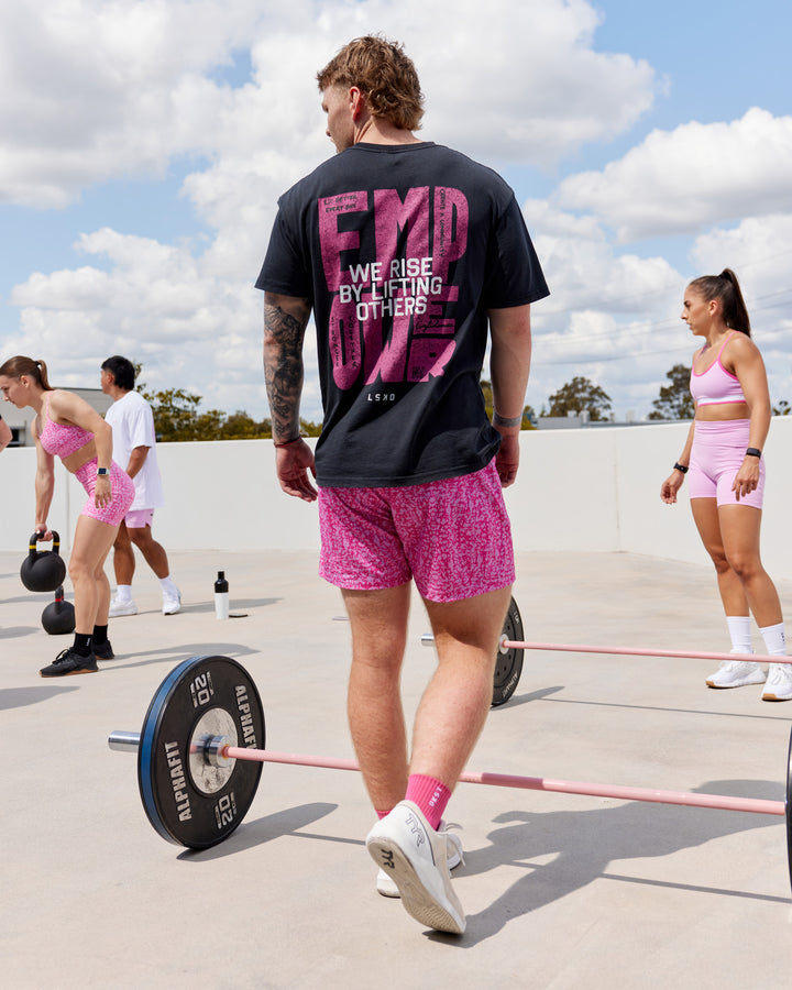 Man wearing Unisex Washed Empower Tee Oversize - Black-Berry Pink
