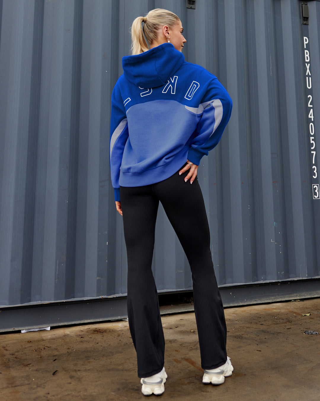 Woman wearing Unisex Y2K Concept Panel Hoodie - Power Cobalt-White