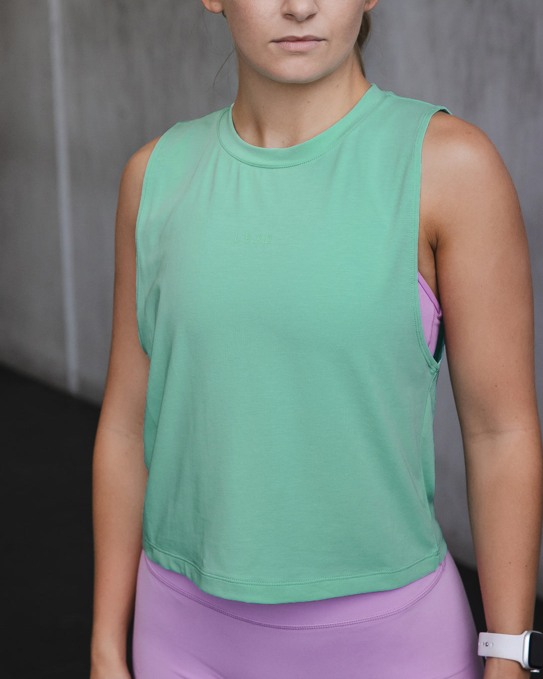 Woman wearing Vital Cropped Training Tank - Cockatoo