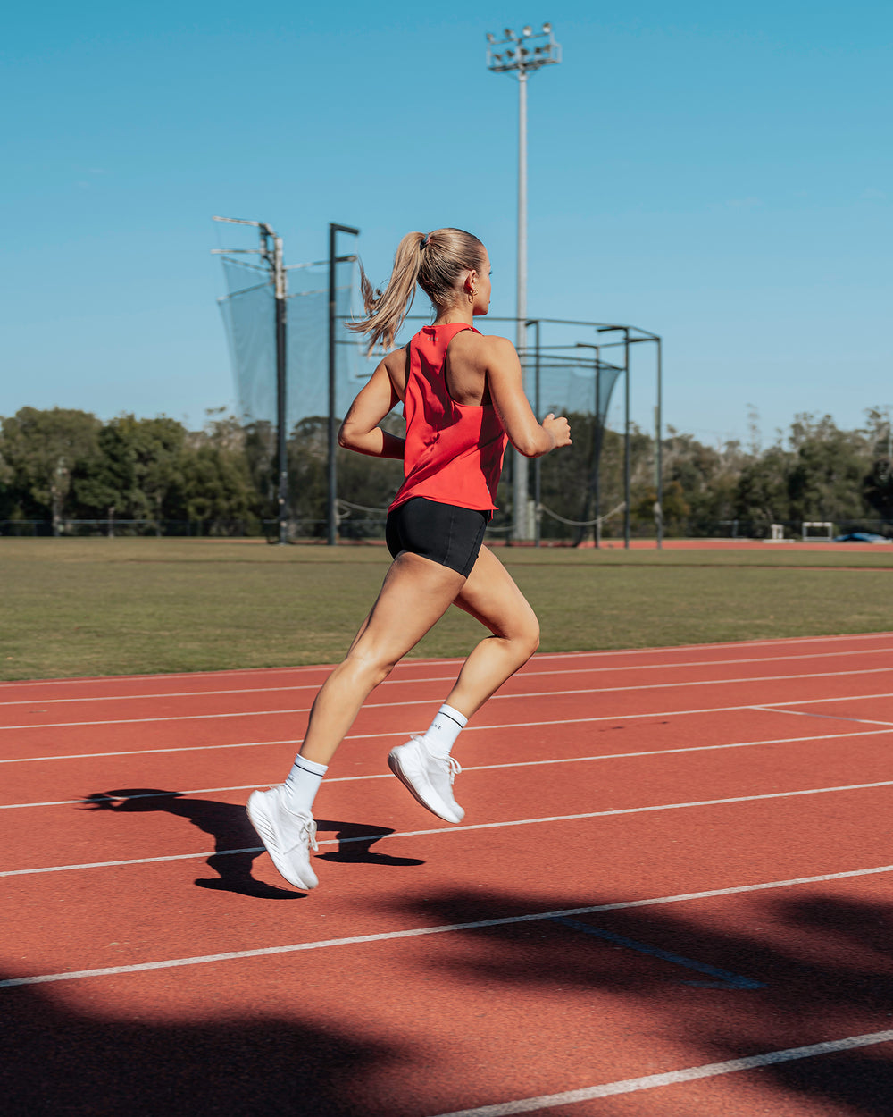 Woman wearing Pace Running Tank - Scarlet