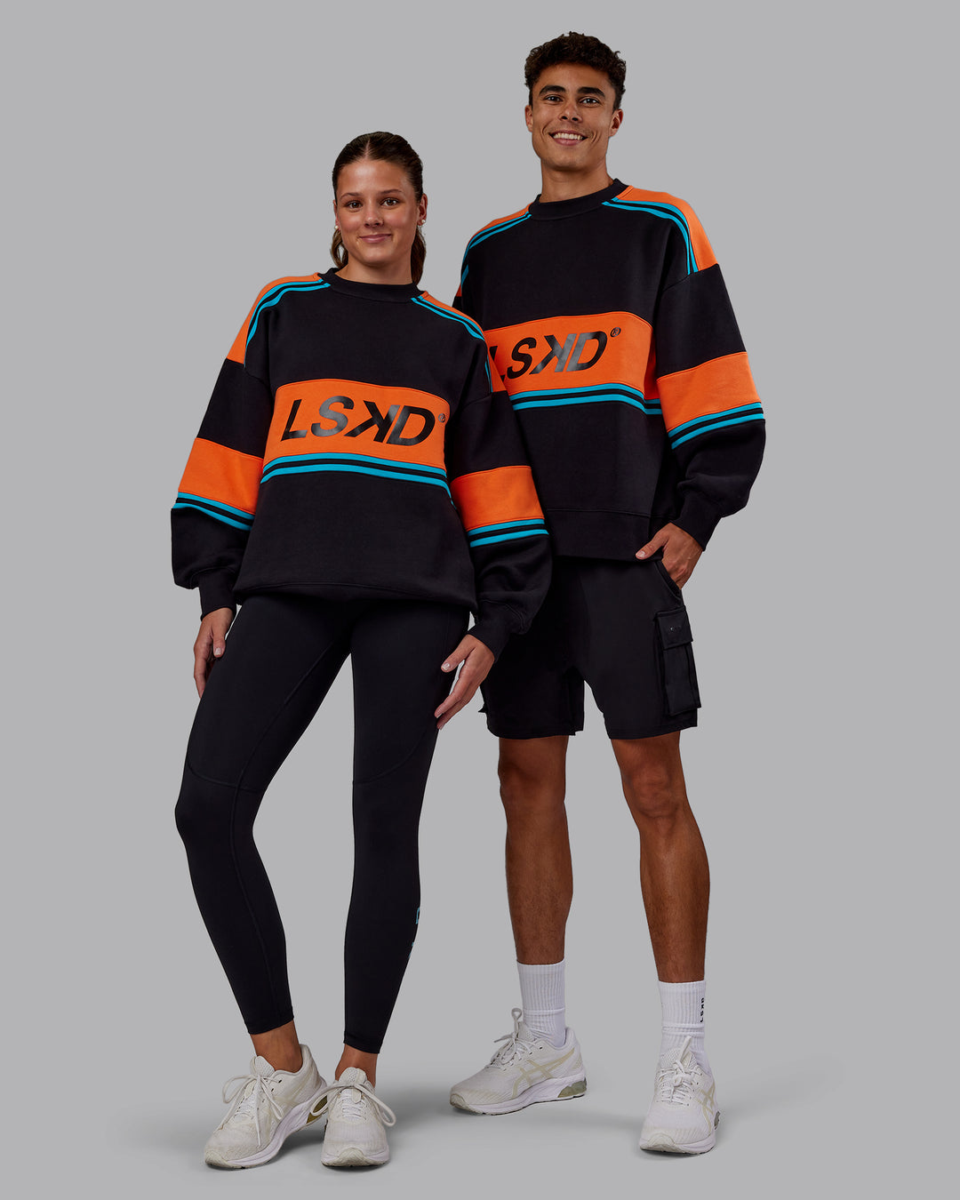 Duo wearing A-Team Sweater Oversize - Black-Ultra Orange | Model:Both | Size:Duo