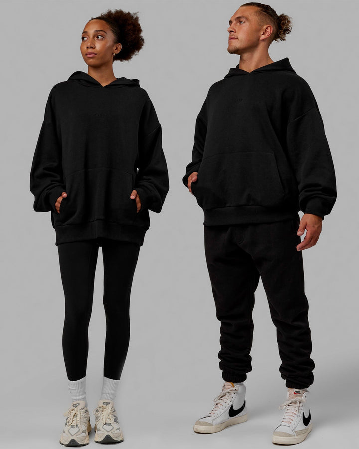 Duo wearing Unisex MVP Hoodie Oversize - Black
