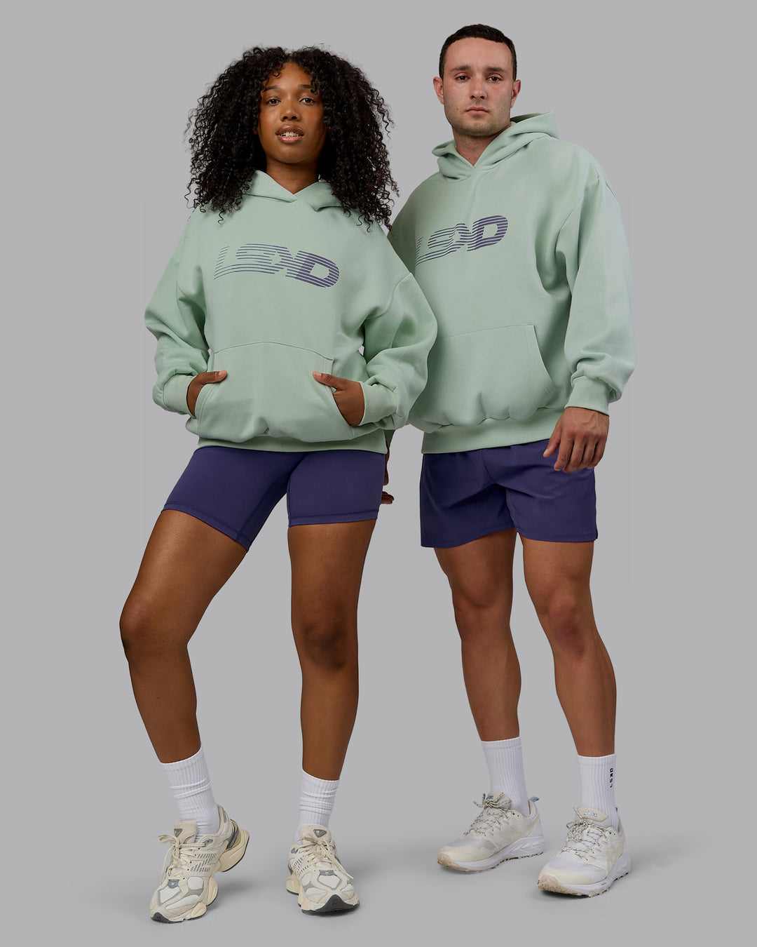 Duo wearing Unisex Motion Hoodie Oversize - Surf Spray-Royal Purple