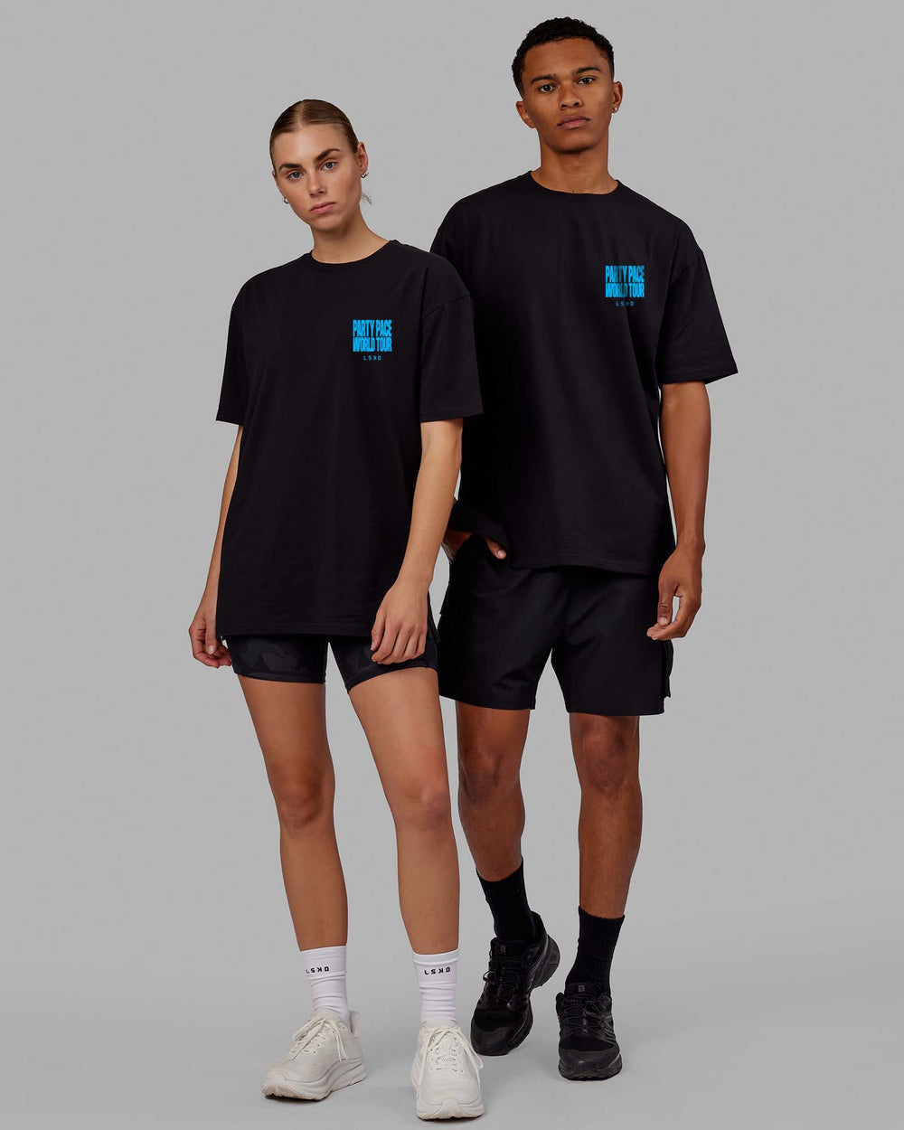 Duo wearing Unisex Party Pace FLXCotton Oversize Tee - Black-Blue  Edit alt text