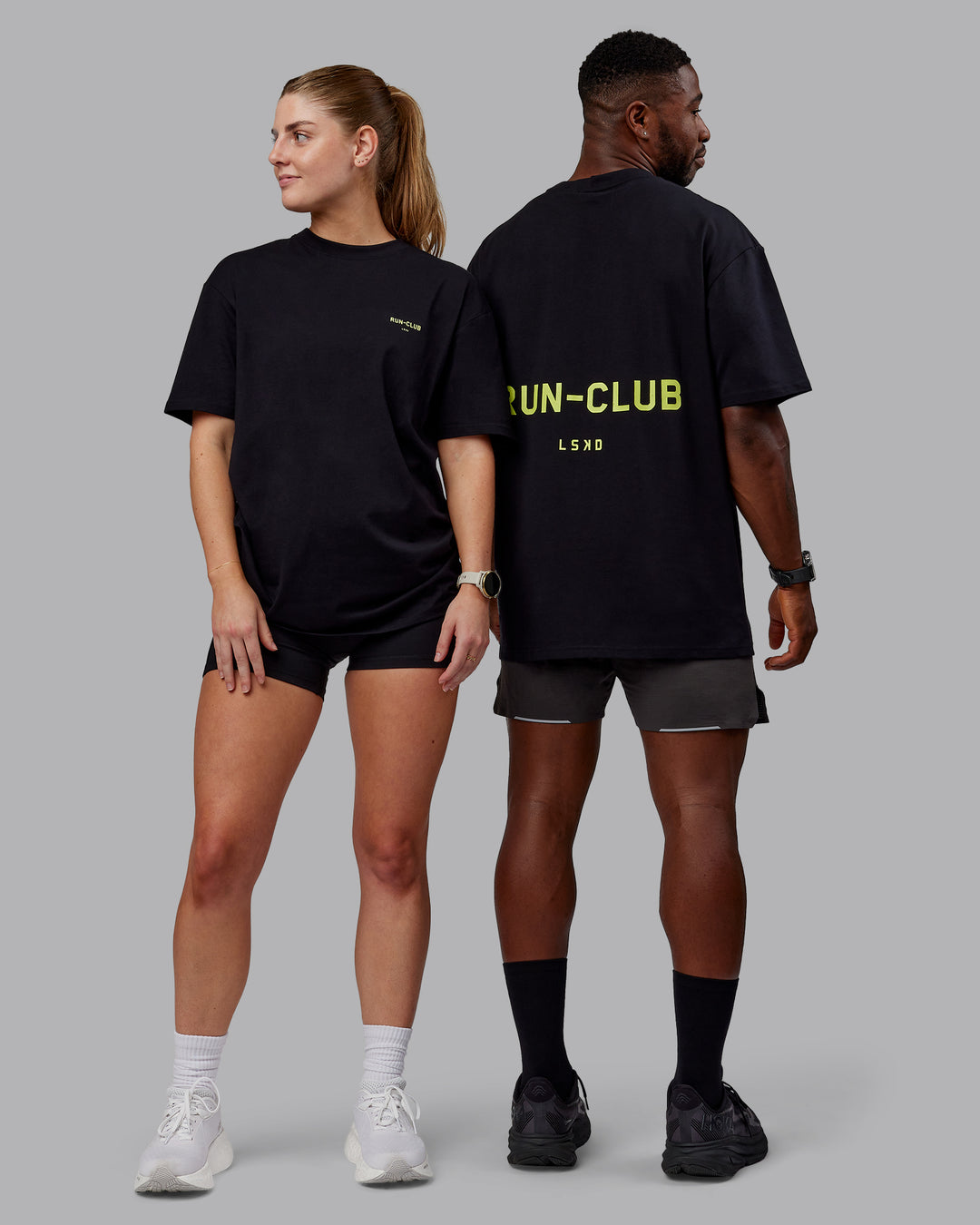 Duo wearing Unisex RUN CLUB FLXCotton Tee Oversize - Black-Volt