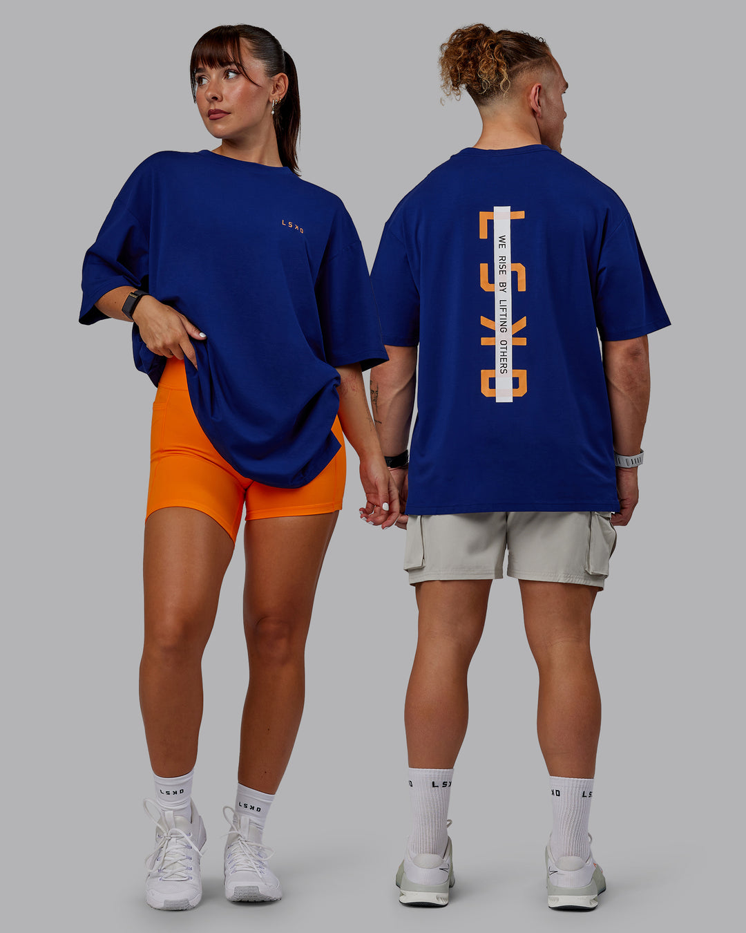 Duo wearing Unisex Strike Through FLXCotton Tee Oversize - Midnight Blue-Vibrant Orange