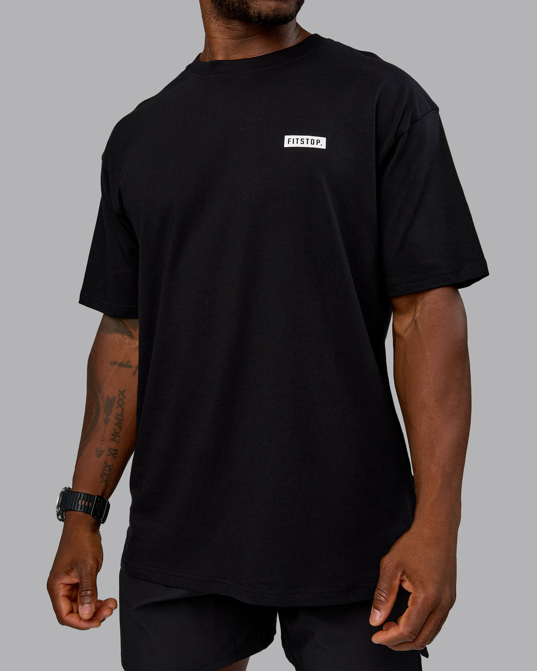 Man wearing Fitstop Embrace the Sweat FLXCotton Oversized Tee in Black-White | Size:L