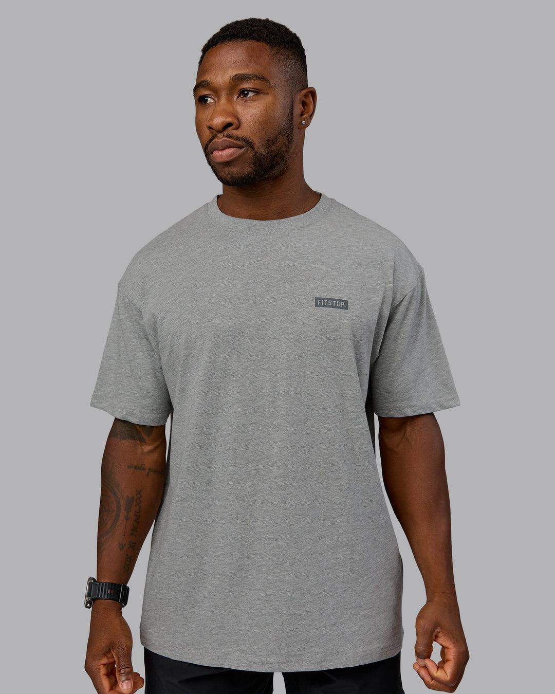 Man wearing Fitstop Embrace the Sweat FLXCotton Oversized Tee in Light Grey Marl-Cool Grey | Size:L