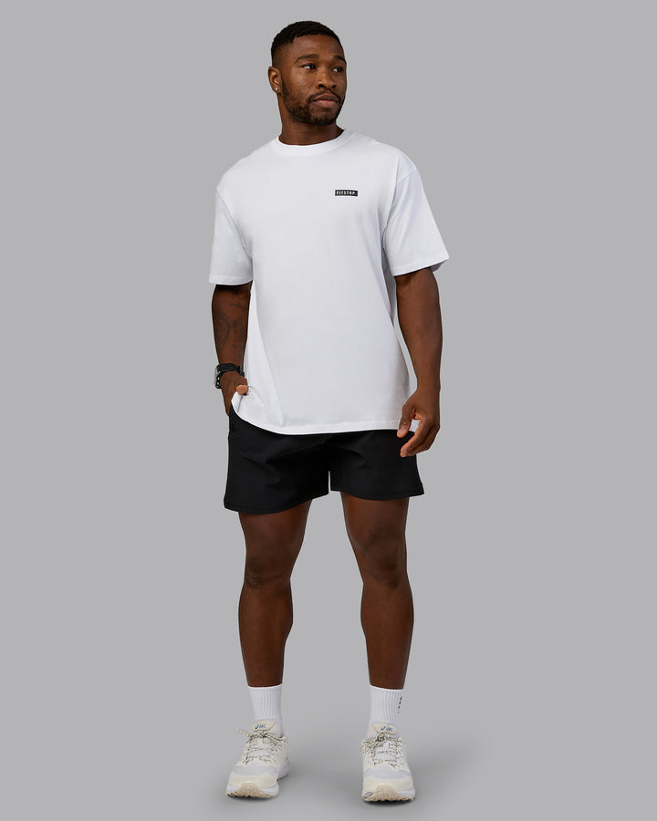 Man wearing Fitstop Embrace the Sweat FLXCotton Oversized Tee in White-Black | Size:L
