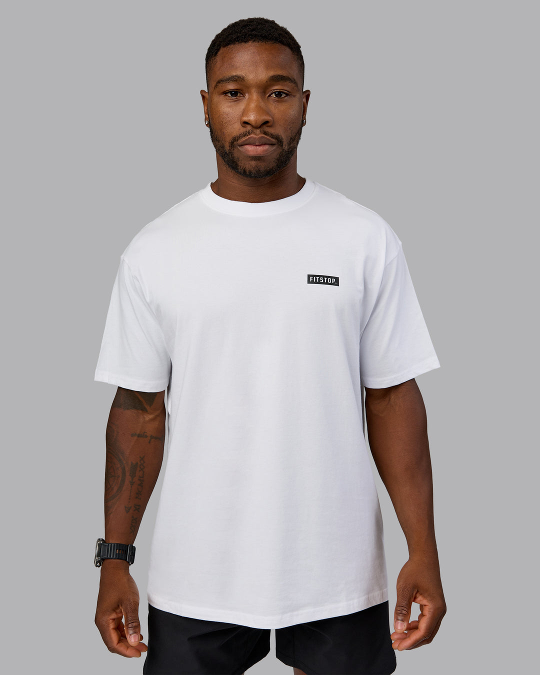 Man wearing Fitstop Embrace the Sweat FLXCotton Oversized Tee in White-Black | Size:L