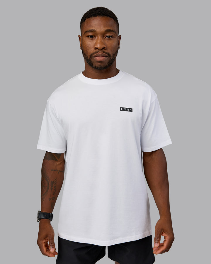 Man wearing Fitstop Embrace the Sweat FLXCotton Oversized Tee in White-Black | Size:L
