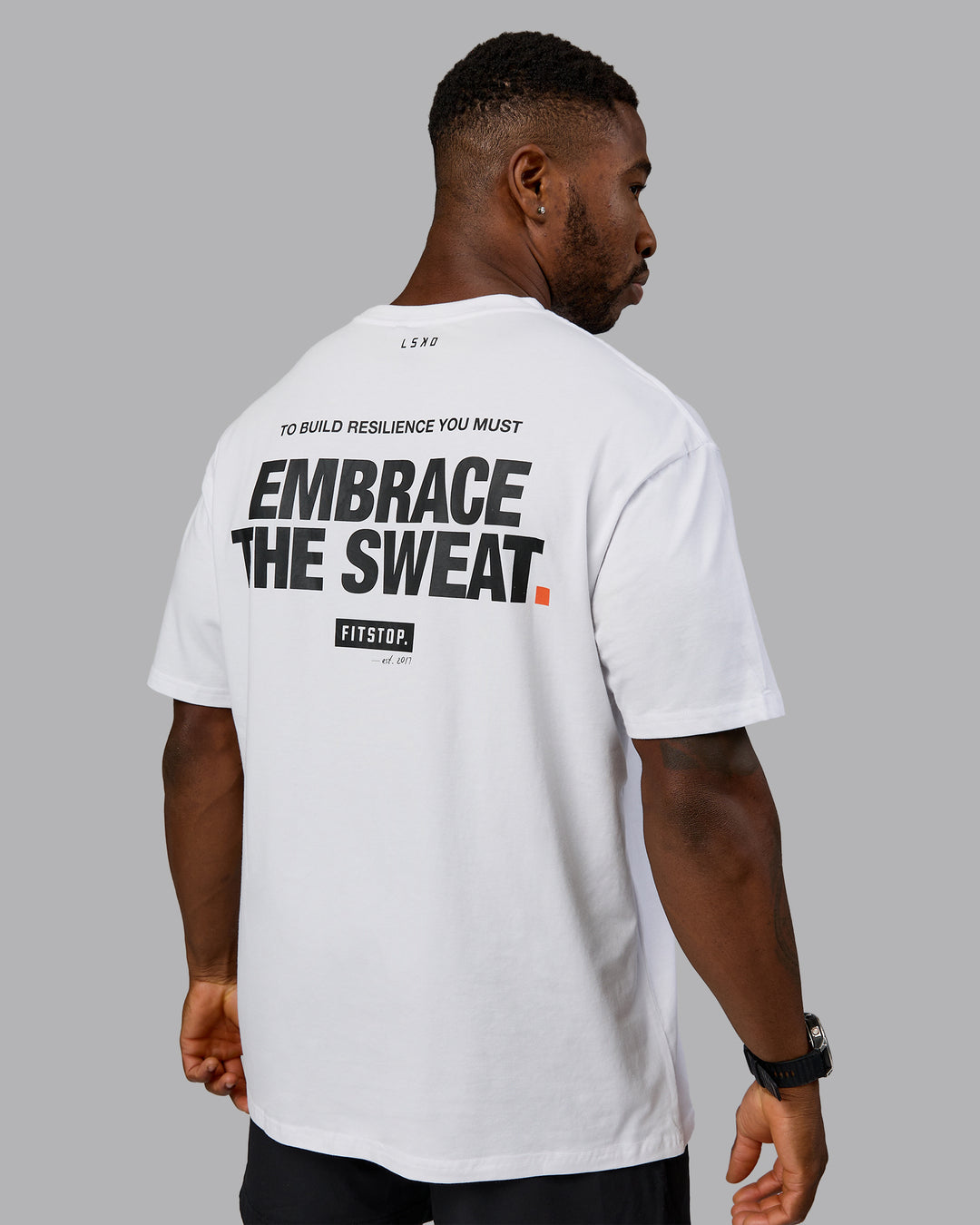 Man wearing Fitstop Embrace the Sweat FLXCotton Oversized Tee in White-Black | Size:L