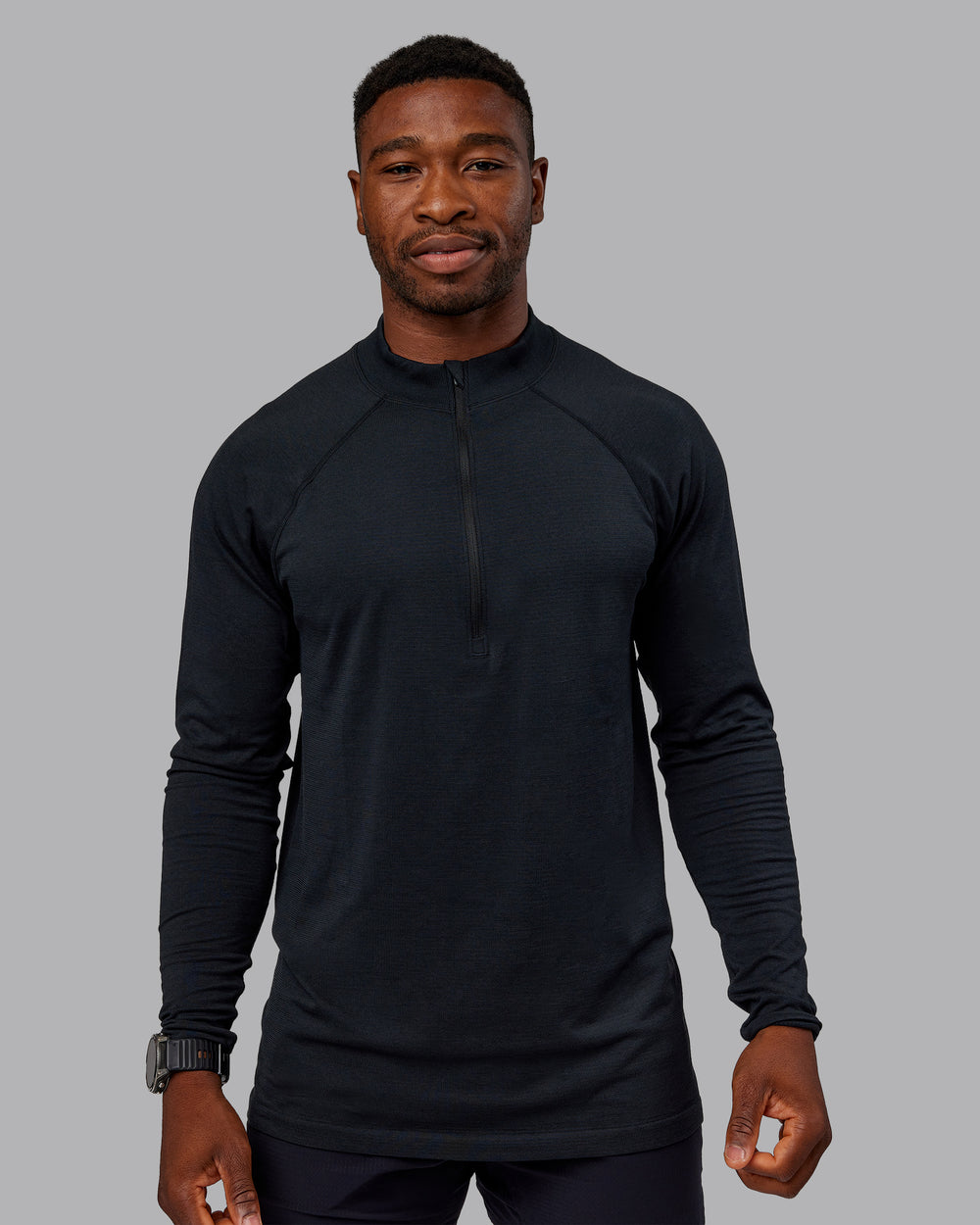 Man wearing AeroFLX+ Seamless Half Zip Long Sleeve Tee - Black/Black | Model:Sam | Size:L