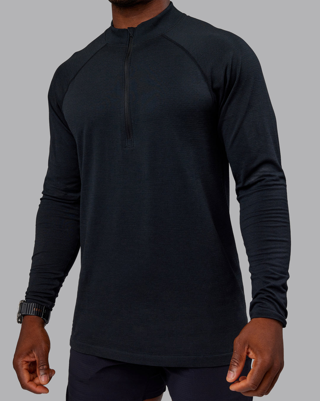 Man wearing AeroFLX+ Seamless Half Zip Long Sleeve Tee - Black/Black | Model:Sam | Size:L