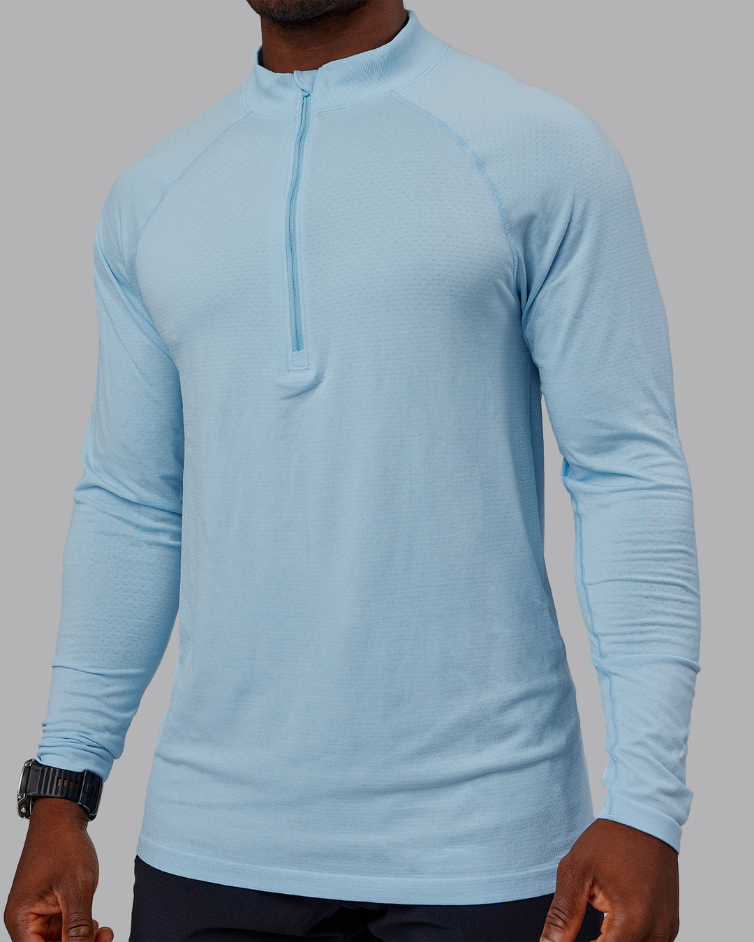 Man wearing AeroFLX+ Seamless Half Zip Long Sleeve Tee - Glacial Blue/Glacial Blue | Model:Sam | Size:L