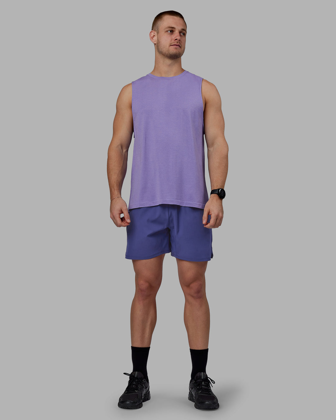 Man wearing AeroFLX+ Seamless Muscle Tank - Dahlia Purple Marl