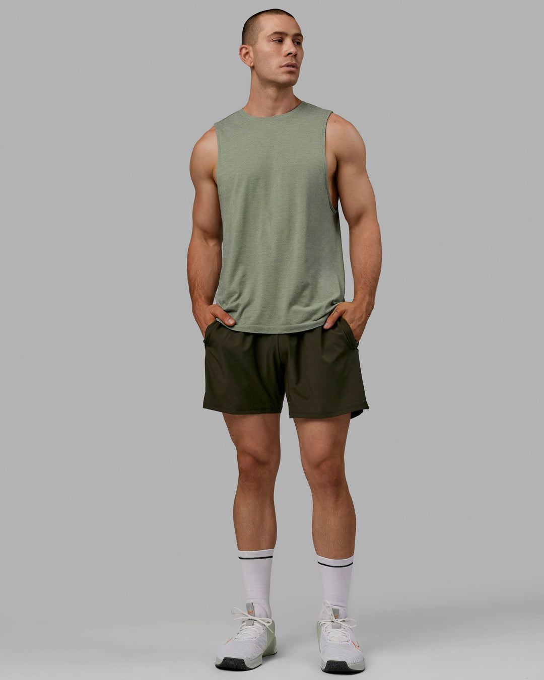 Man wearing AeroFLX+ Seamless Muscle Tank - Iceberg Green Marl