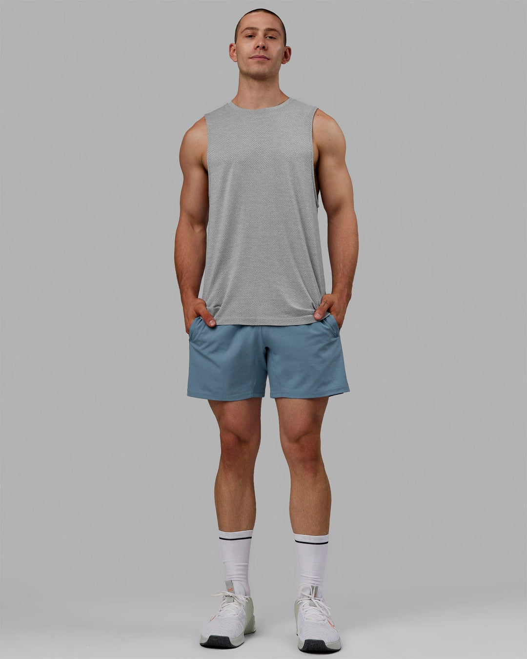 Man wearing AeroFLX+ Seamless Muscle Tank - Lt Grey Marl