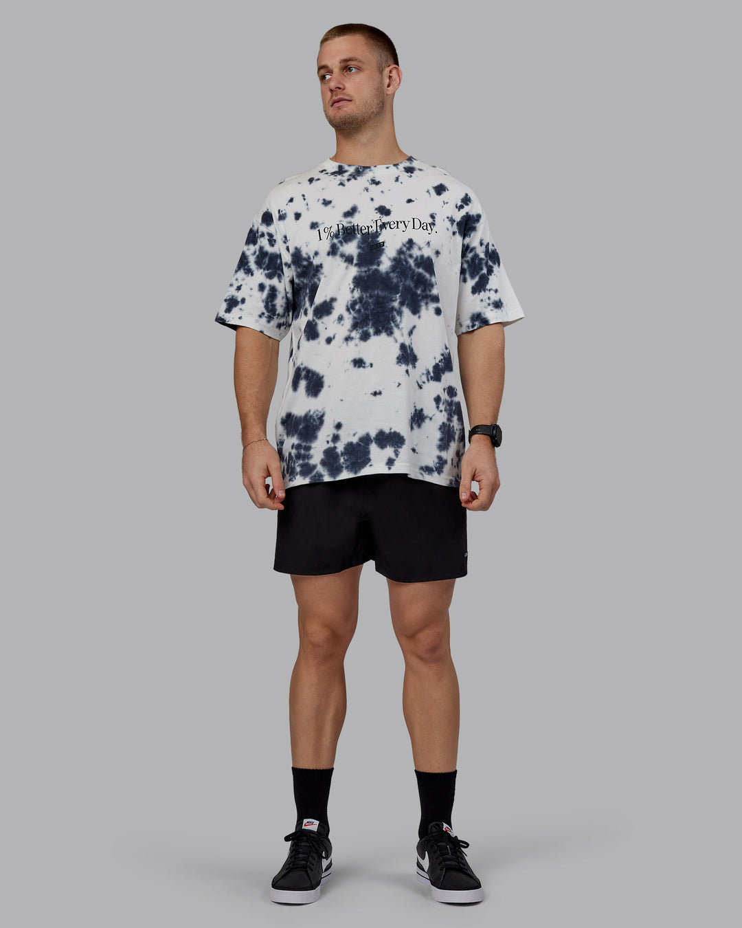 Man wearing Unisex 1% Better Heavyweight Tee Oversize - White-Black Tie Dye