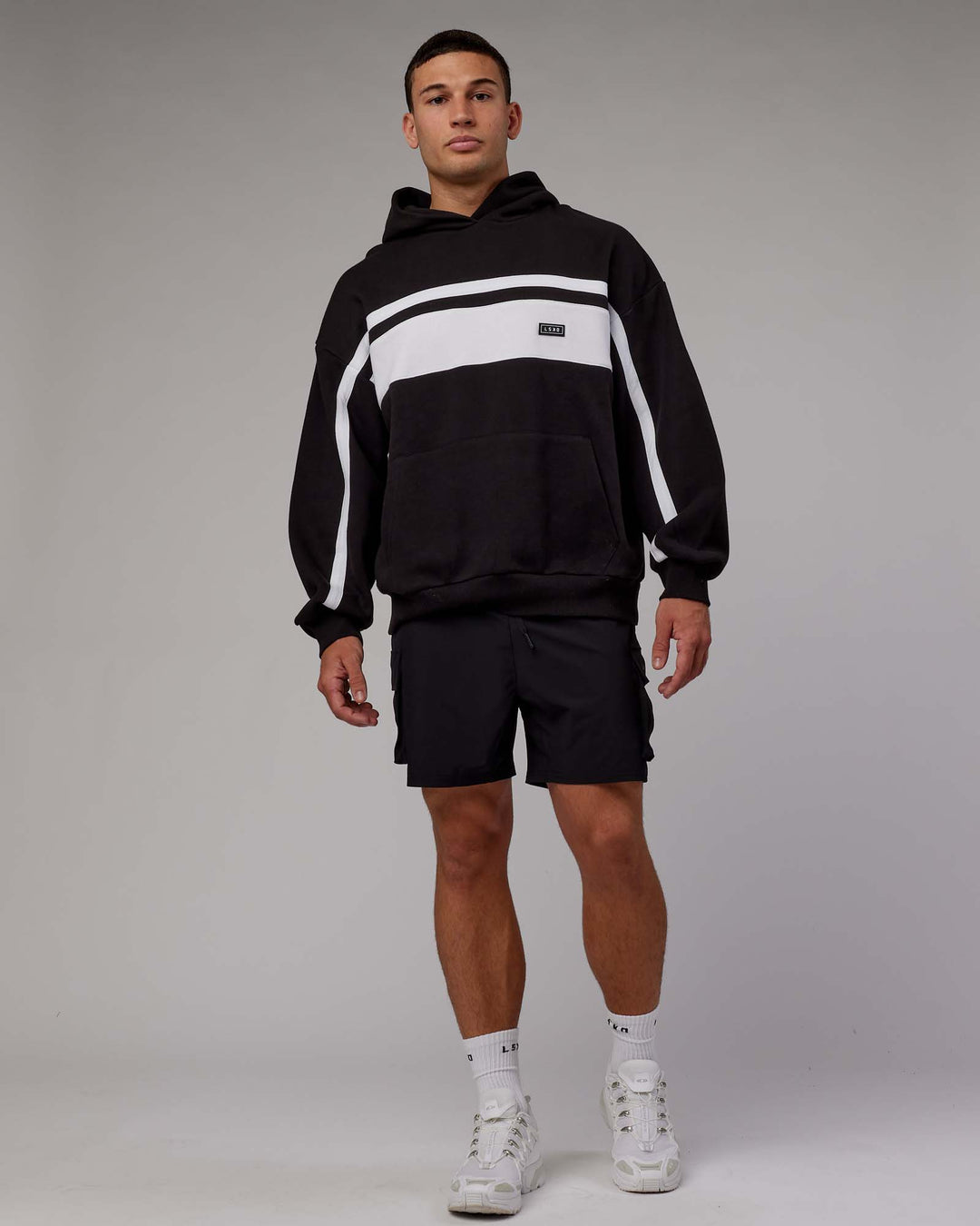 Man wearing Unisex Intercept Hoodie Oversize - Black-White