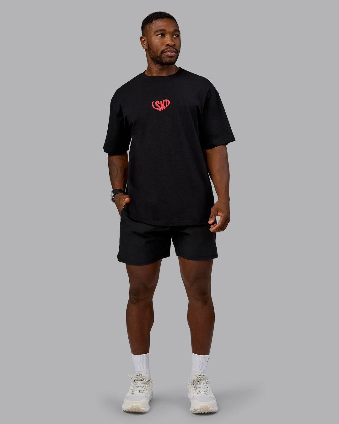 Man wearing Unisex Love To Train FLXCotton Tee Oversize in Black-Scarlet | Size:L