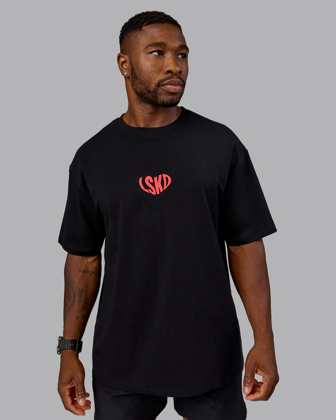 Man wearing Unisex Love To Train FLXCotton Tee Oversize in Black-Scarlet | Size:L