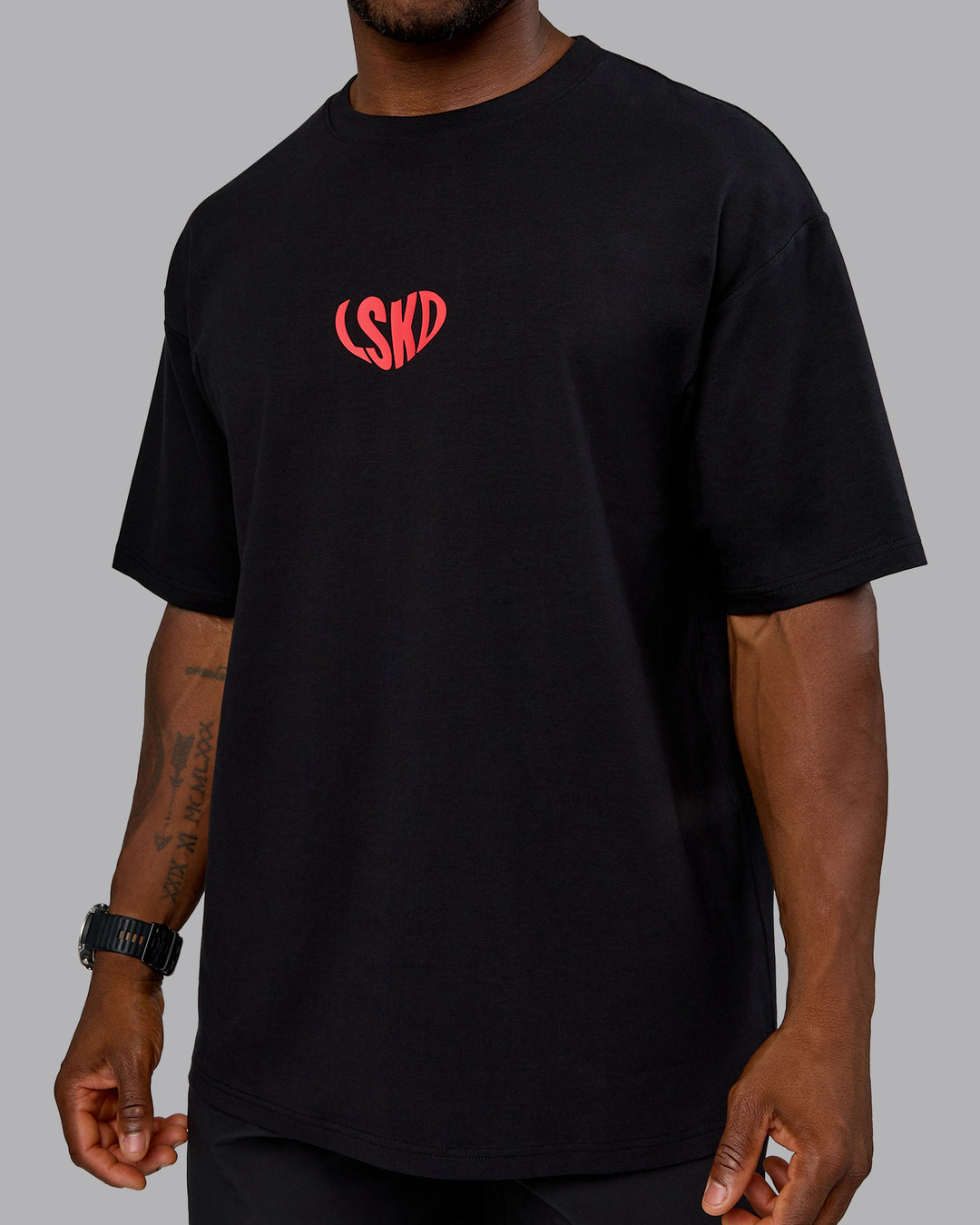 Man wearing Unisex Love To Train FLXCotton Tee Oversize in Black-Scarlet | Size:L