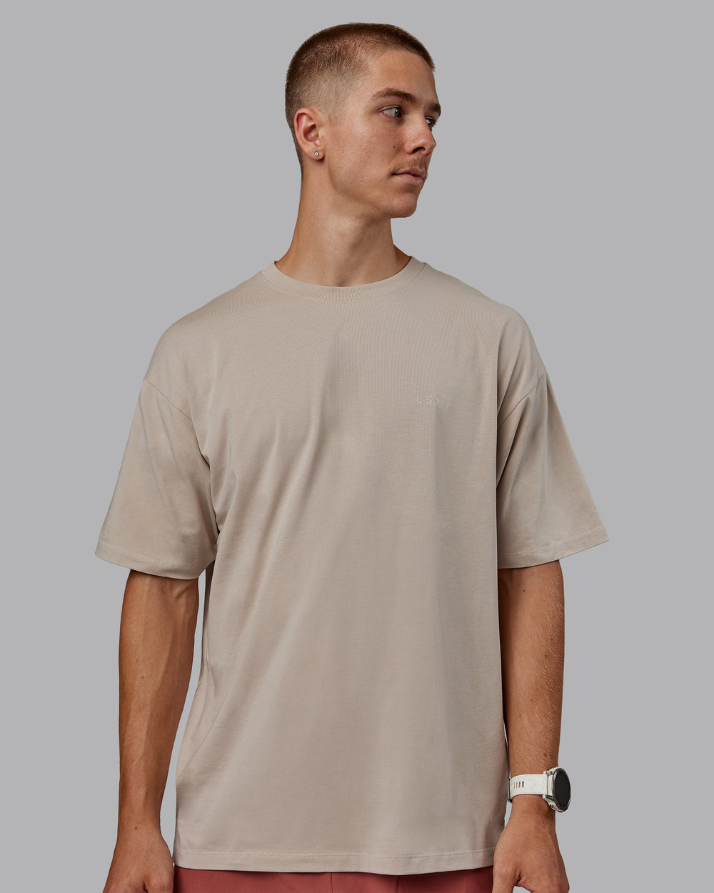 Man wearing Unisex PimaFLX Tee Oversize in Shale Beige | Size:L