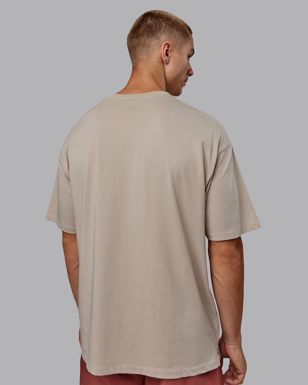 Man wearing Unisex PimaFLX Tee Oversize in Shale Beige | Size:L